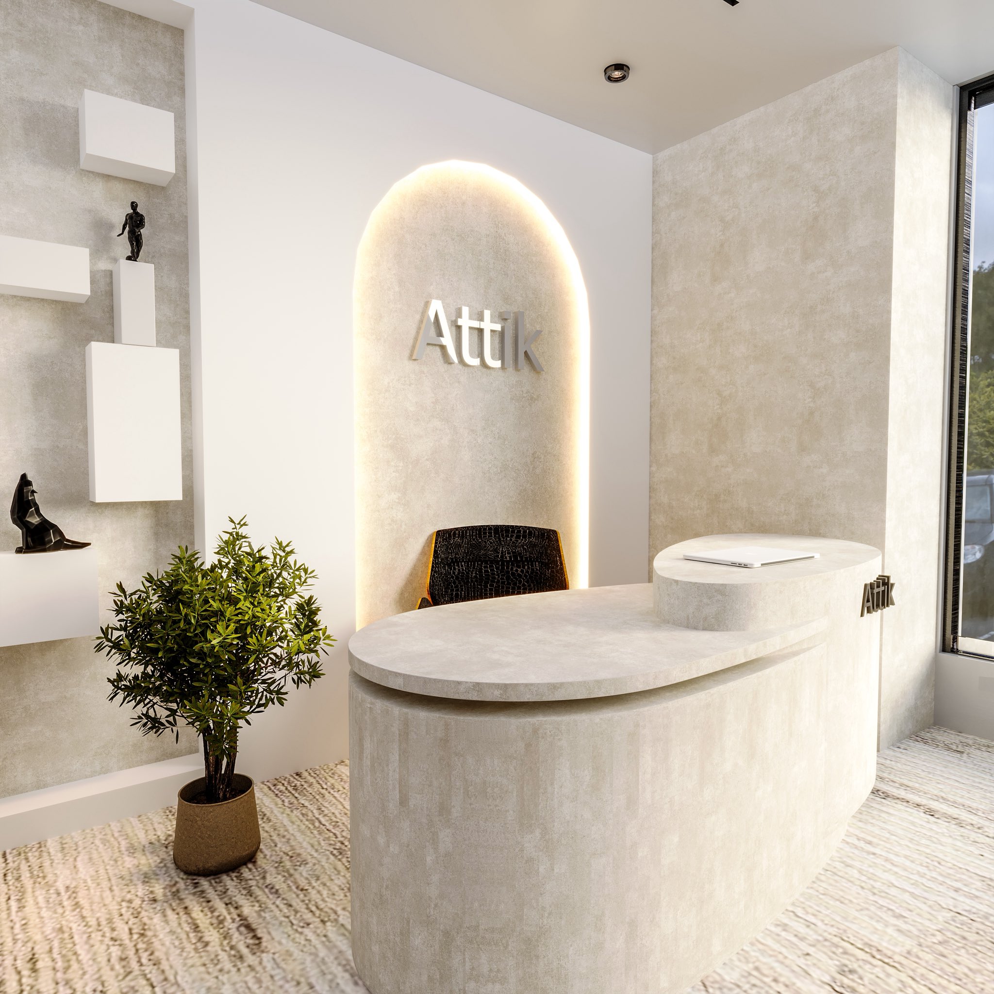 The curved plaster reception desk with the Attik name lit on the wall behind it